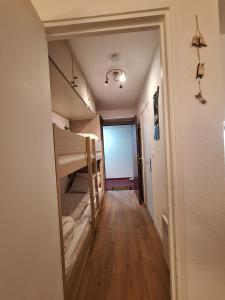 a hallway with two bunk beds in a room at Studio Les 3 Lys Auron in Auron