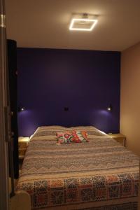 a bedroom with a large bed with a blue wall at Best view in the Bay! in Athens