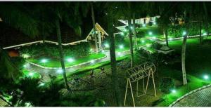 a view of a street at night with green lights at Nijaguna Residency in Chāmrājnagar