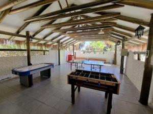 two ping pong tables in a room with wooden ceilings at Cabañas La Huayca - Caja Los Andes in Pica