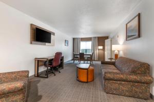 a living room with a couch and a desk at Comfort Inn & Suites in Lake George