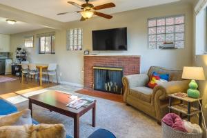 a living room with a couch and a fireplace at Denver Vacation Rental Near Parks and Attractions! in Denver