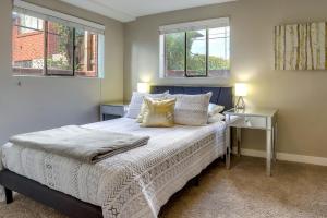 a bedroom with a bed and two windows at Denver Vacation Rental Near Parks and Attractions! in Denver