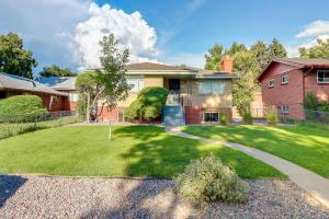 a house with a grass yard with a driveway at Denver Vacation Rental Near Parks and Attractions! in Denver