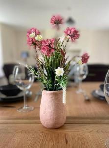 a pink vase filled with flowers on a table at Dundonagh House, Glaslough, in Monaghan