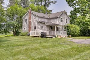 a white house with a porch and a yard at Peaceful Upstate New York Home with Yard and Fire Pit! in Walden