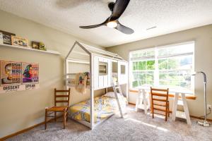 a bedroom with a bunk bed and two chairs at Cozy Iowa City Home about 2 Mi to Kinnick Stadium! in Iowa City