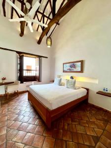a bedroom with a large bed in a room at Misia Custodia Hotel Boutique in Barichara +103 photos