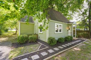 a small green house with bushes in front of it at Springfield Home with Yard 3 Mi to Downtown! in Springfield