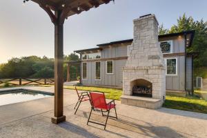 a patio with a brick fireplace next to a house at Tree-Lined Whitney Cabin about 11 Mi to Lake Whitney! in Whitney