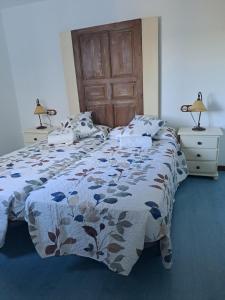 La Fragua I y II في Rebollar: غرفة نوم مع سرير مع لحاف من الزهور
