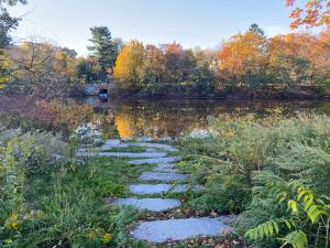 a stepping stone path next to a lake at Luxury 3 bdr apt with backyard and off-street parking in Watertown