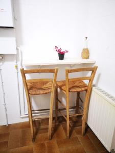 uma mesa de cozinha com 2 cadeiras e uma mesa branca em Cal Boix Apartamento em Tremp