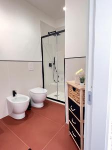 a bathroom with a toilet and a glass shower at Valguarnera Studio Apartments in Palermo