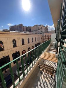 a balcony with two benches on a building at Valguarnera Studio Apartments in Palermo