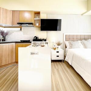 a kitchen and a bedroom with a bed and a table at Cebu City Scape at Cebu IT Park in Cebu City