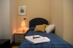 A bed or beds in a room at B&B La Cittadella Univeristaria Policlinico Catania