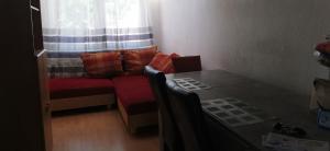 a living room with a couch and a table at Maison Room in Karlsruhe