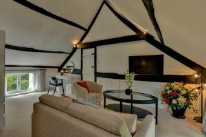 a living room with a couch and a table at Tranquil Apartment at Ashton in Sidmouth