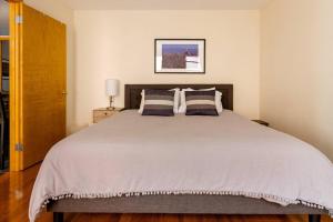 a bedroom with a large bed with two pillows at 2 Bedroom King Bed Apartment in New York