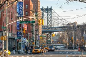 a busy city street with a bridge in the background at 2 Bedroom King Bed Apartment in New York