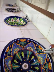 two plates on a counter with a sink on it at Huitzilin Hostal in Brisas de Zicatela
