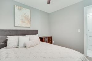 a white bedroom with a large bed with white pillows at Edmond Home Near Colleges, Lakes, and Shopping! in Edmond