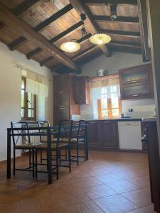 a kitchen with wooden cabinets and a table and chairs at Le Macine in Magnano