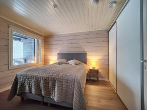 - une chambre avec un lit dans une pièce dotée d'une fenêtre dans l'établissement Rukan Timantti A, à Ruka