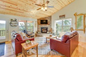 a living room with leather furniture and a fireplace at North Carolina Cabin - Pool Table and Mountain Views in Murphy