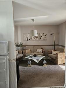 ein Wohnzimmer mit einem Sofa und einem Tisch in der Unterkunft Gästehaus3land in Weil am Rhein in Weil am Rhein