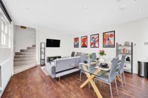 a living room with a glass table and a couch at Luxury 3 bedroom house in Limehouse, close to city! Sleeps 6-8! in London
