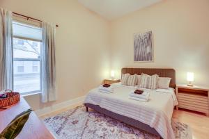 a bedroom with a bed and a large window at Chic Wilmington Condo in Brooklyn Arts District! in Wilmington