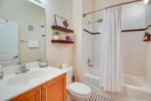 a bathroom with a sink and a toilet and a tub at Chic Wilmington Condo in Brooklyn Arts District! in Wilmington +17 photos