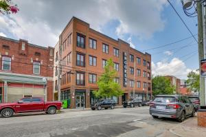 a street with cars parked in front of a brick building at Chic Wilmington Condo in Brooklyn Arts District! in Wilmington