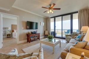 a living room with a couch and a tv at Dauphin Island Condo in Holiday Isle with Balcony! in Dauphin Island