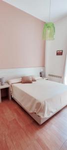 a bedroom with a large white bed in a room at Il Quadrifoglio Room& Suite in Palermo