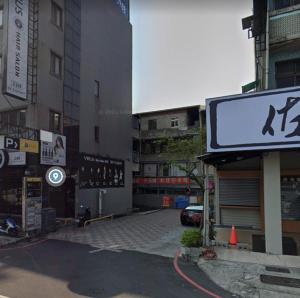 a city street with buildings and a sign on the street at 小鹿之家 in Taichung