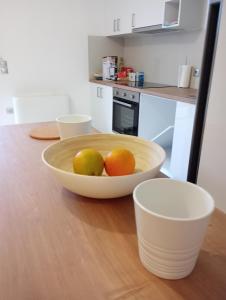 a bowl of fruit on a table in a kitchen at Coastal Garden Getaway in Metókhi