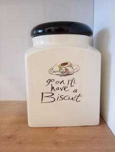 a jar with a sign that says you cant have a biscuit at Coastal Garden Getaway in Metókhi