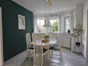 a dining room with a table and chairs at Lueg36 am See in Sankt Gilgen