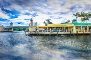 a building on a dock on a body of water at Saltwater pool, FREE beach passes & GREAT location! in Boynton Beach