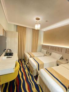 Dar Al Naem Hotel tesisinde bir odada yatak veya yataklar