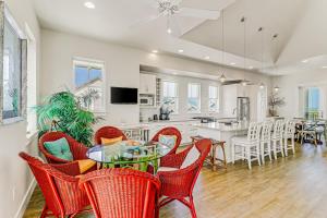 a dining room and kitchen with a table and chairs at Sunset Cove at Palmilla Beach in Port Aransas