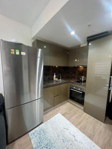 a kitchen with a stainless steel refrigerator and a stove at Luxury Residence in Istanbul