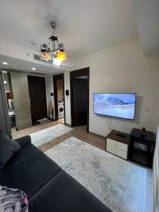 a living room with a couch and a flat screen tv at Luxury Residence in Istanbul