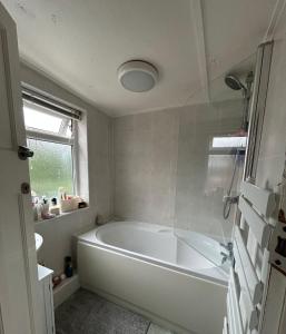 a white bath tub in a bathroom with a window at Double room in Heaton in Heaton