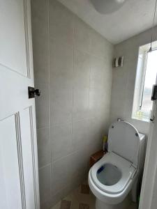 a small bathroom with a toilet and a window at Double room in Heaton in Heaton