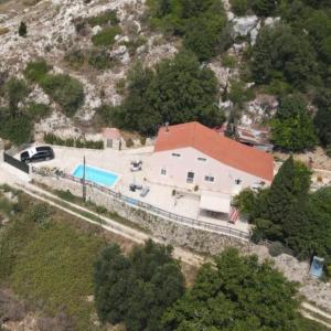 an aerial view of a house with a swimming pool at Villa Serenity in Vovikes