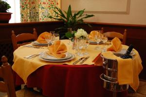 a table with plates and glasses and napkins on it at Benny Hotel in Catanzaro